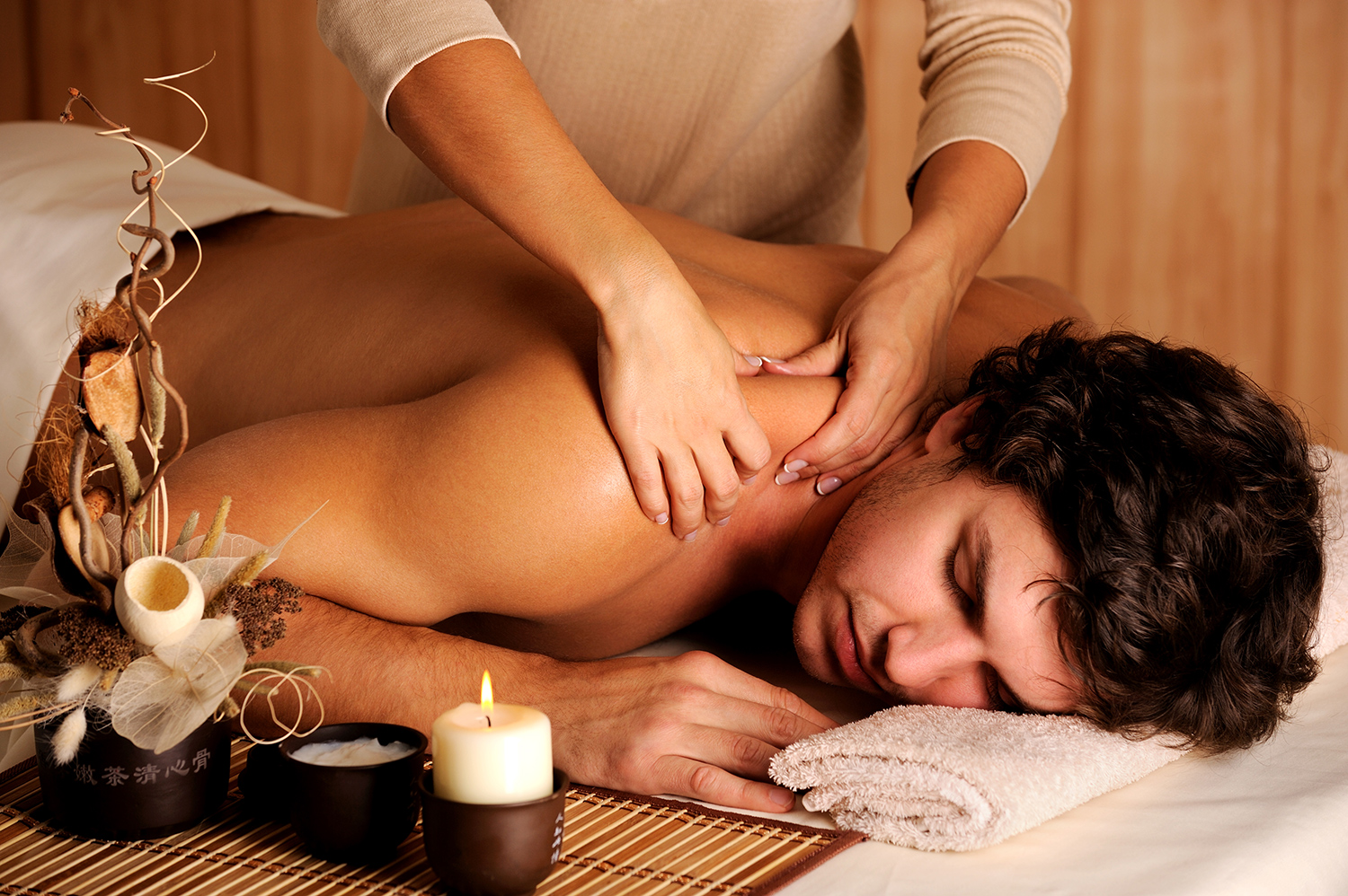 Therapeutic shoulder massage in a warm spa room